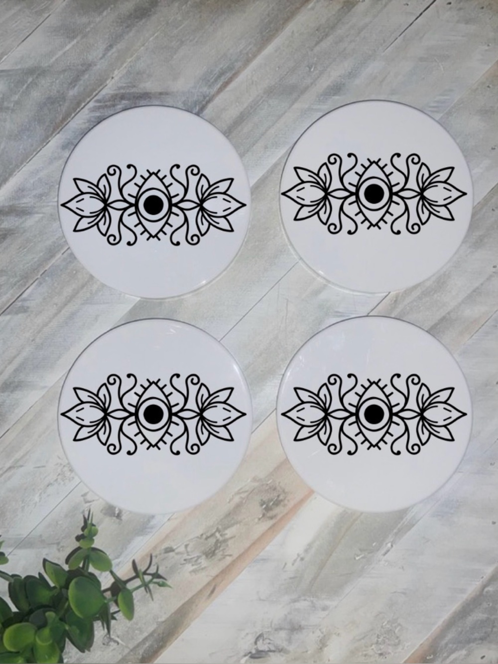Set of Four White Ceramic Coasters with Black Eye Motif
